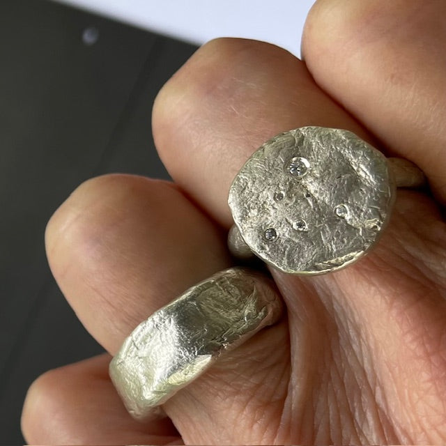 Cosmic Crater Ring in silver with Relic Ring In Silver on persons hand