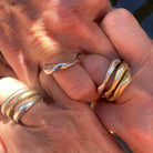 Close-up of hands wearing Alchemist Stacking Rings and Single Element Ring 