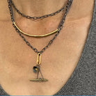 Multiple Necklaces layered. Bar Necklace in Bronze. Also, the Truth and Balance Talisman Pendants on the Oxidized Silver Chain with gold paper clip connector. 
