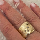 Close up of Five Elements Ring in Bronze on persons hand 