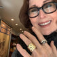 Customer wearing the silver with white diamond devotion ring; the oxidized silver with salt and pepper diamond devotion ring; the bronze five elements ring