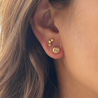 Evil Eye Stud Earrings n 18kt Gold and Hoshi Stud Earrings in 18kt Gold on a person 