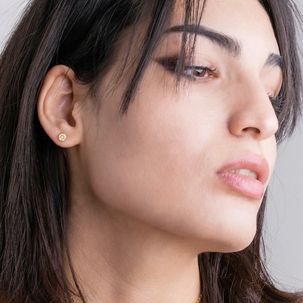 A captivating blend of ancient symbolism and modern elegance. At its center, a 2mm salt and pepper diamond is flush-set, adding an ethereal sparkle that catches the light with every movement. The Evil Eye Stud in 18kt Gold is designed for versatility, perfect for everyday wear or special occasions.