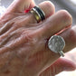 Cosmic Crater Ring in silver with Elemental Harmony Ring Stack on persons hand 