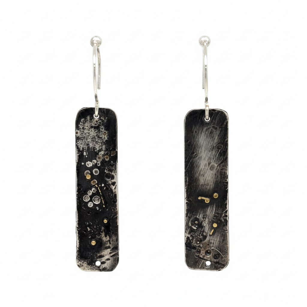 Embrace the weathered beauty of Whidbey Island's shores with our Driftwood Earrings. They capture the essence of sun-bleached wood transformed by its journey through salt and sea, reimagined in precious metals.