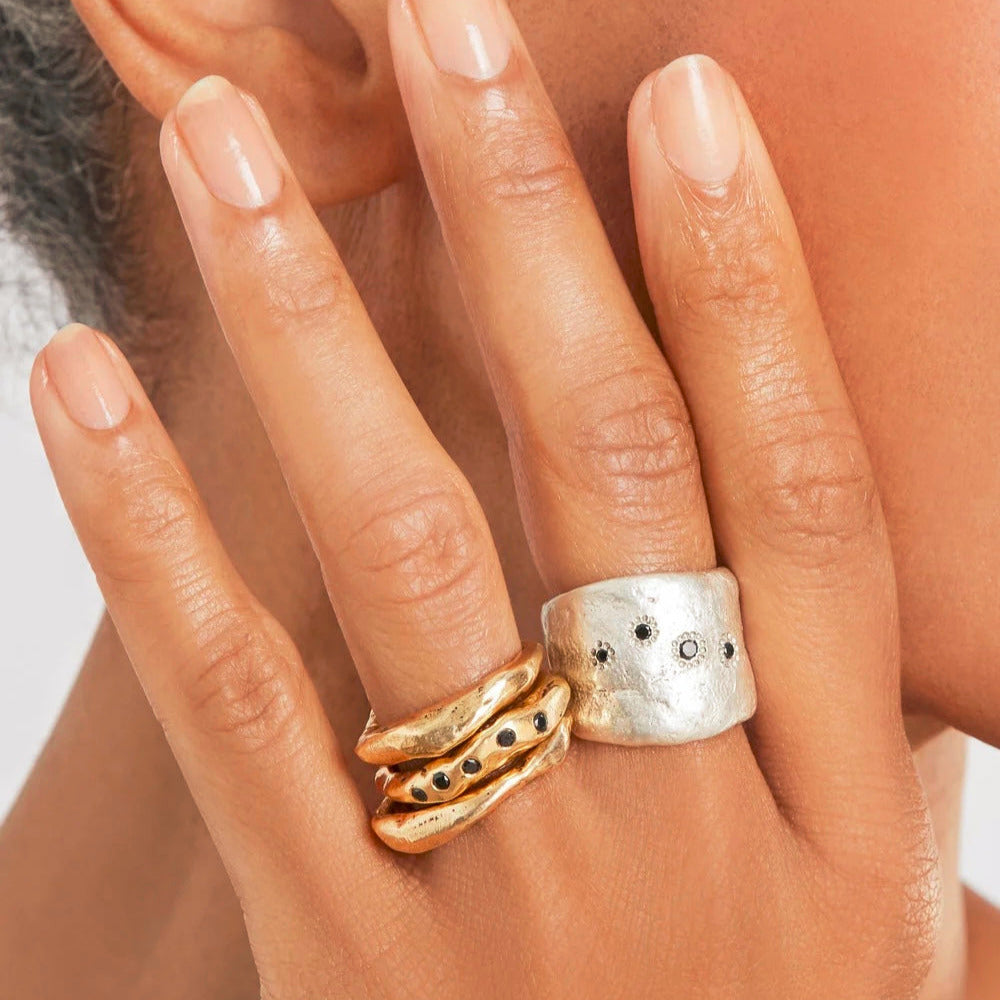 The Five Elements Ring is a stunning tribute to the five elements of nature - water, wood, fire, earth and metal. The unique and meaningful design features five black diamonds, representing each element and its significance in Japanese culture.  Handcrafted with a wide band that is deceptively comfortable, this ring is designed to be worn every day as a reminder to stay present and connected to the planet. 