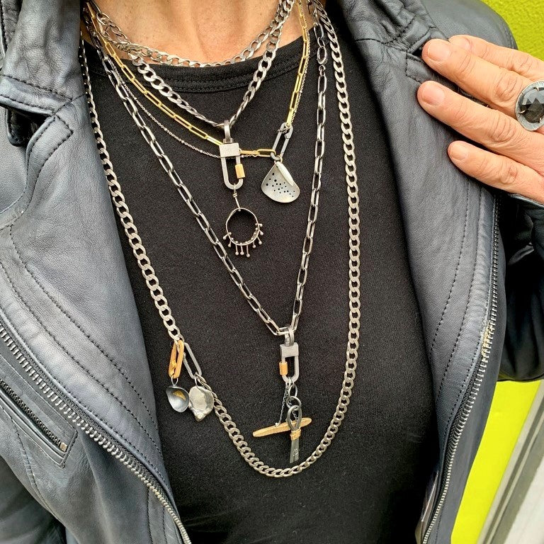 We've combined two cool oxidized sterling chains - one is a chunky flat curb & the other a large link oval on this layered necklace. You can add a few Talisman to the Sterling Lock Connector and turn up the volume!