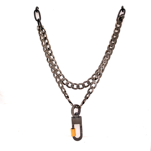 We've combined two cool oxidized sterling chains - one is a chunky flat curb & the other a large link oval on this layered necklace. You can add a few Talisman to the Sterling Lock Connector and turn up the volume!