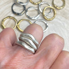 Alchemist Stacking Rings Silver shown on  hand with various Element Rings in background 