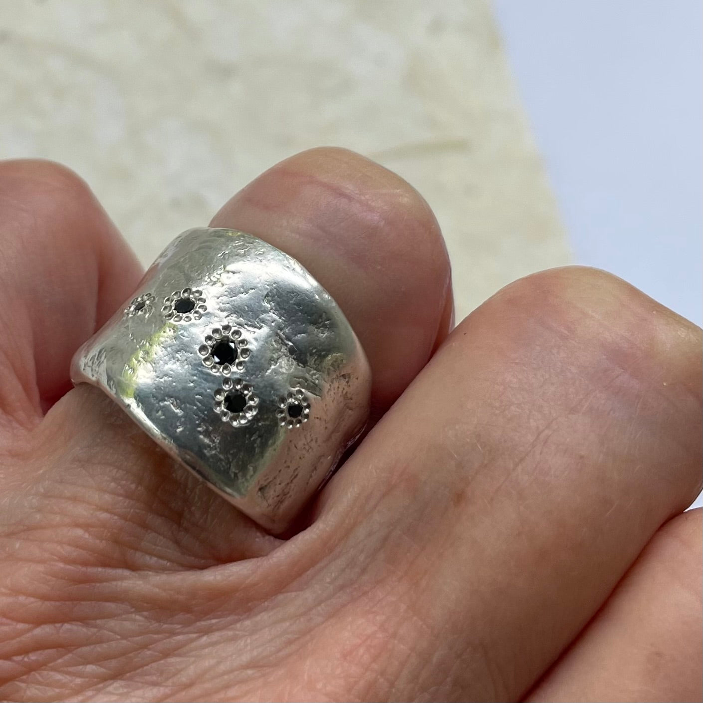 The Five Elements Ring in Silver on persons hand 