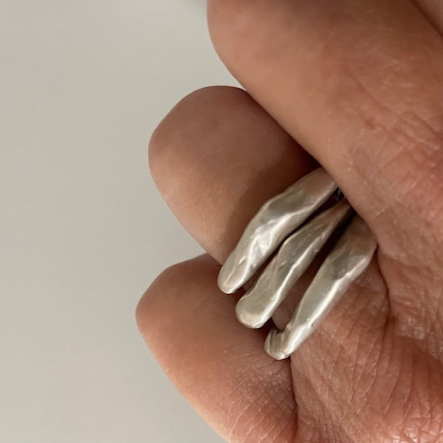 Close up of Alchemist Stacking Rings Silver shown on  hand