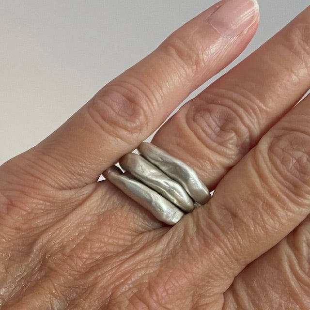 Close up of Alchemist Stacking Rings Silver shown on  hand