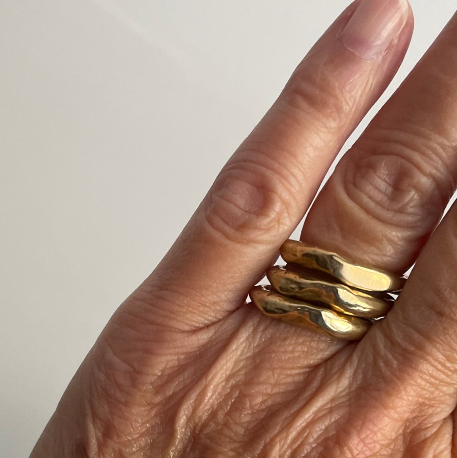  Alchemist Stacking Rings in Bronze on persons hand 