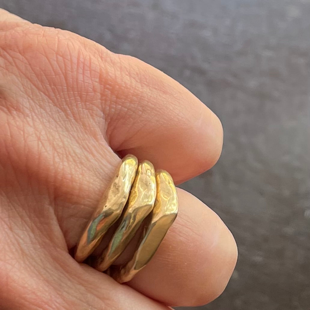 Close up of the Alchemist Stacking Rings in Bronze on hand