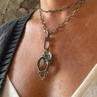 The Lock Connector is made of solid sterling silver with a 18k gold-plated screw closure and is made to swivel so your Talisman Pendants will move with your body.