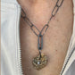 The Love Talisman Necklace on a person wearing a white jacket.
