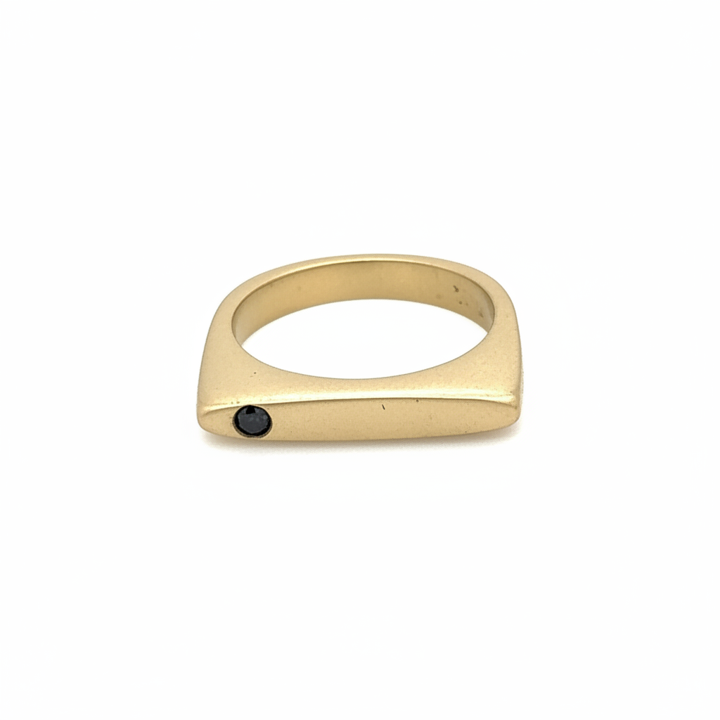 In the most profound moments of transformation, everything is stripped to its essence.This sleek, architectural band captures that moment of clarity with its refined silhouette and single black diamond - like the dark center of an eclipse where revelation occurs in shadow.