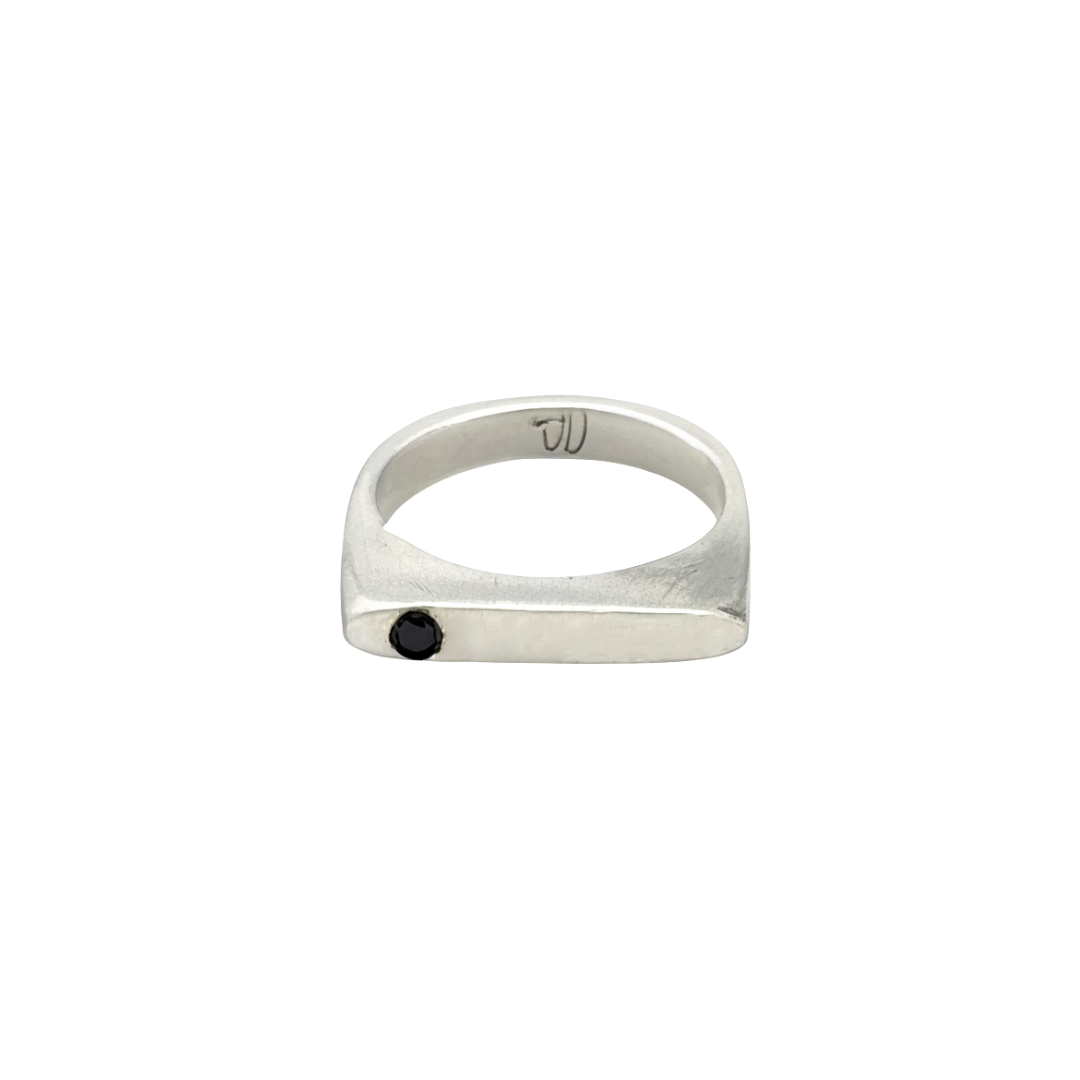 This sleek, architectural band captures that moment of clarity with its refined silhouette and single black diamond - like the dark center of an eclipse where revelation occurs in shadow.