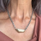 Close Up of Vestige Necklace in Bronze on a person 
