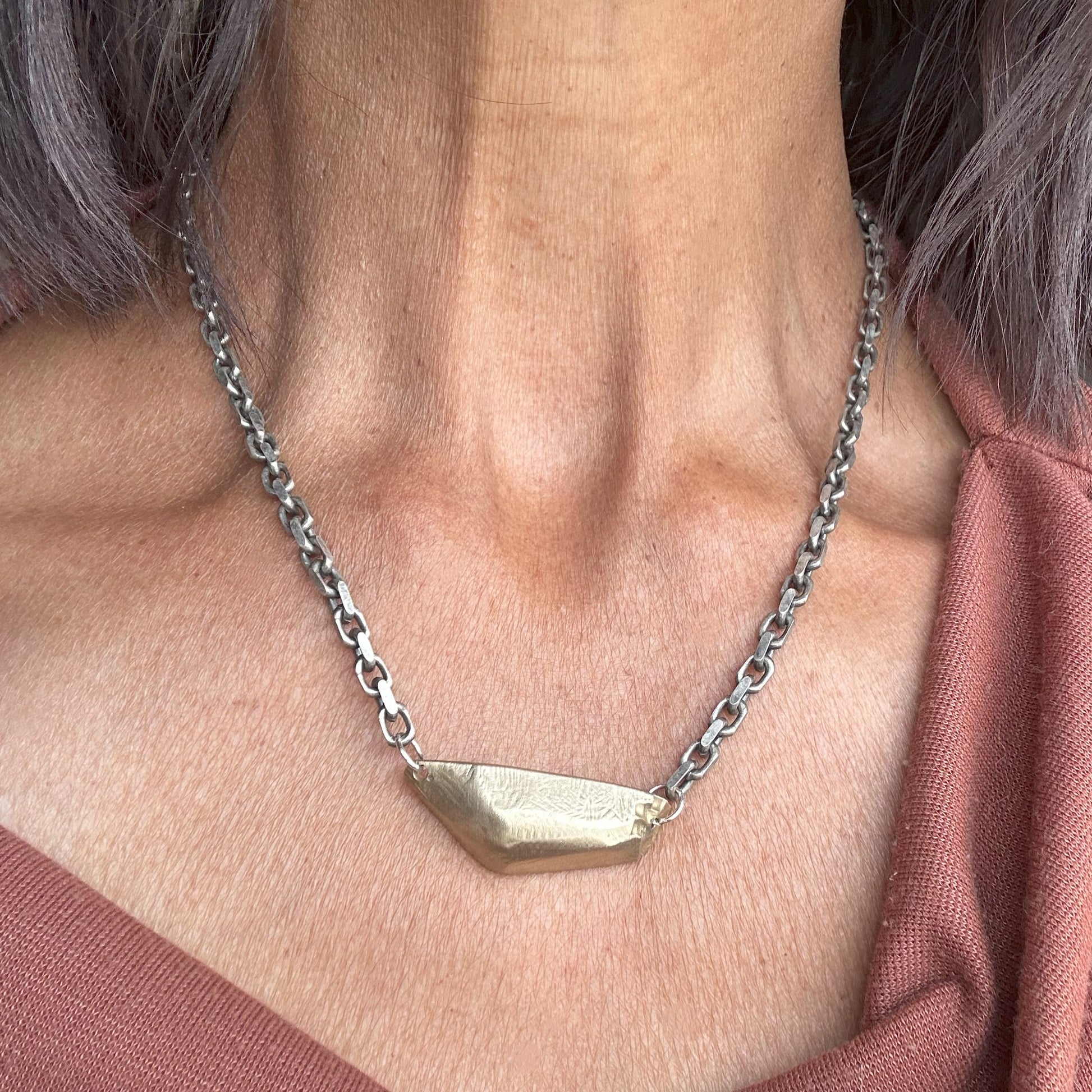 Close Up of Vestige Necklace in Bronze on a person 