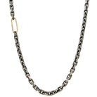 The&nbsp;Spark Chain Necklace is light breaking through shadow. A bold oxidized chain carries weight and presence, interrupted by a single 18k gold link that sparks a reminder that awakening often begins with one luminous choice.