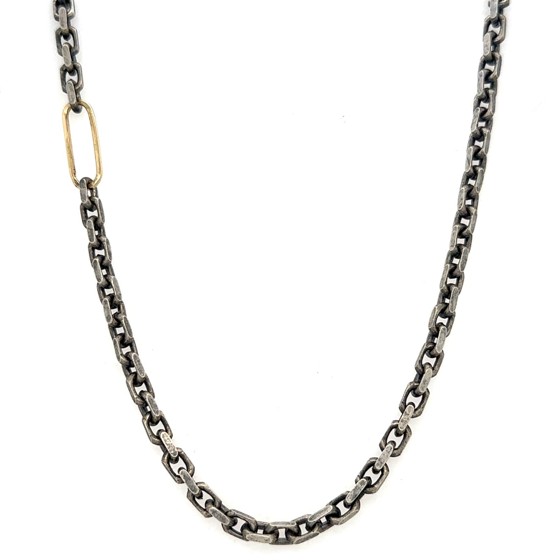 The&nbsp;Spark Chain Necklace is light breaking through shadow. A bold oxidized chain carries weight and presence, interrupted by a single 18k gold link that sparks a reminder that awakening often begins with one luminous choice.
