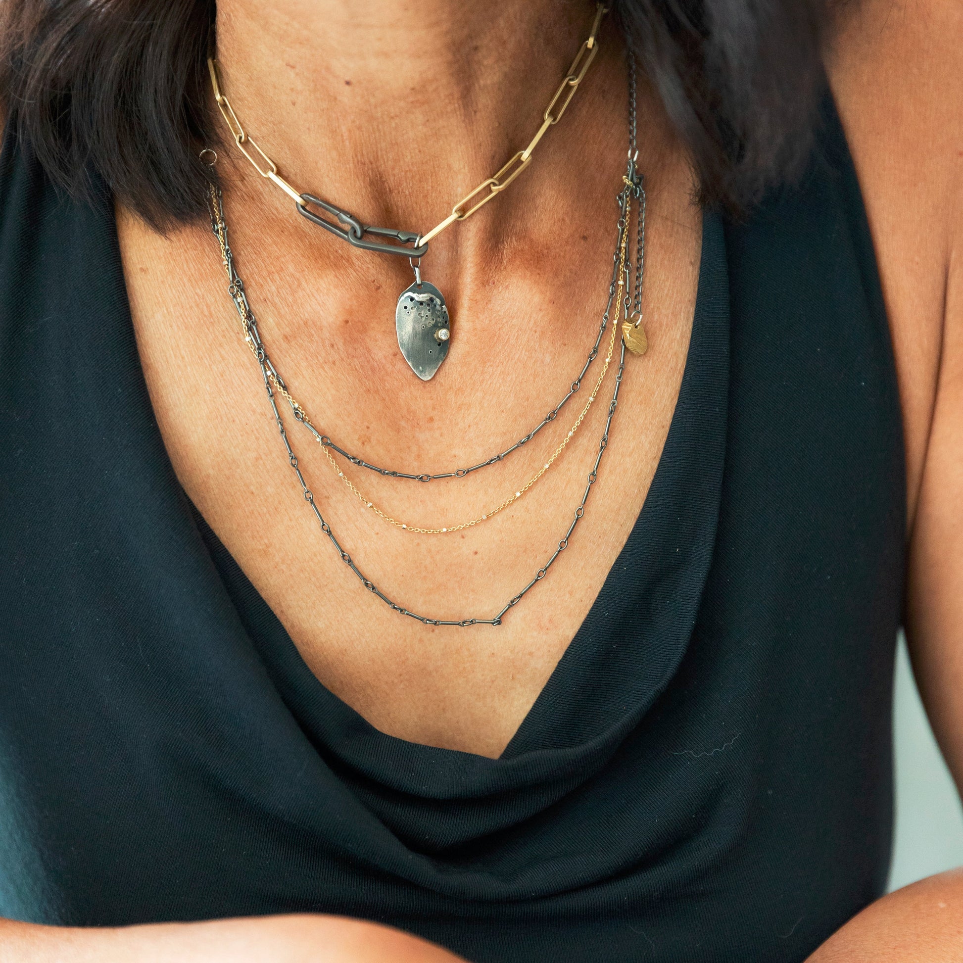 Close up of the Modern Gold Link Chain with Double Paper Clip Clasp and Desire Talisman layered with the Mixed Metal Layered Necklace