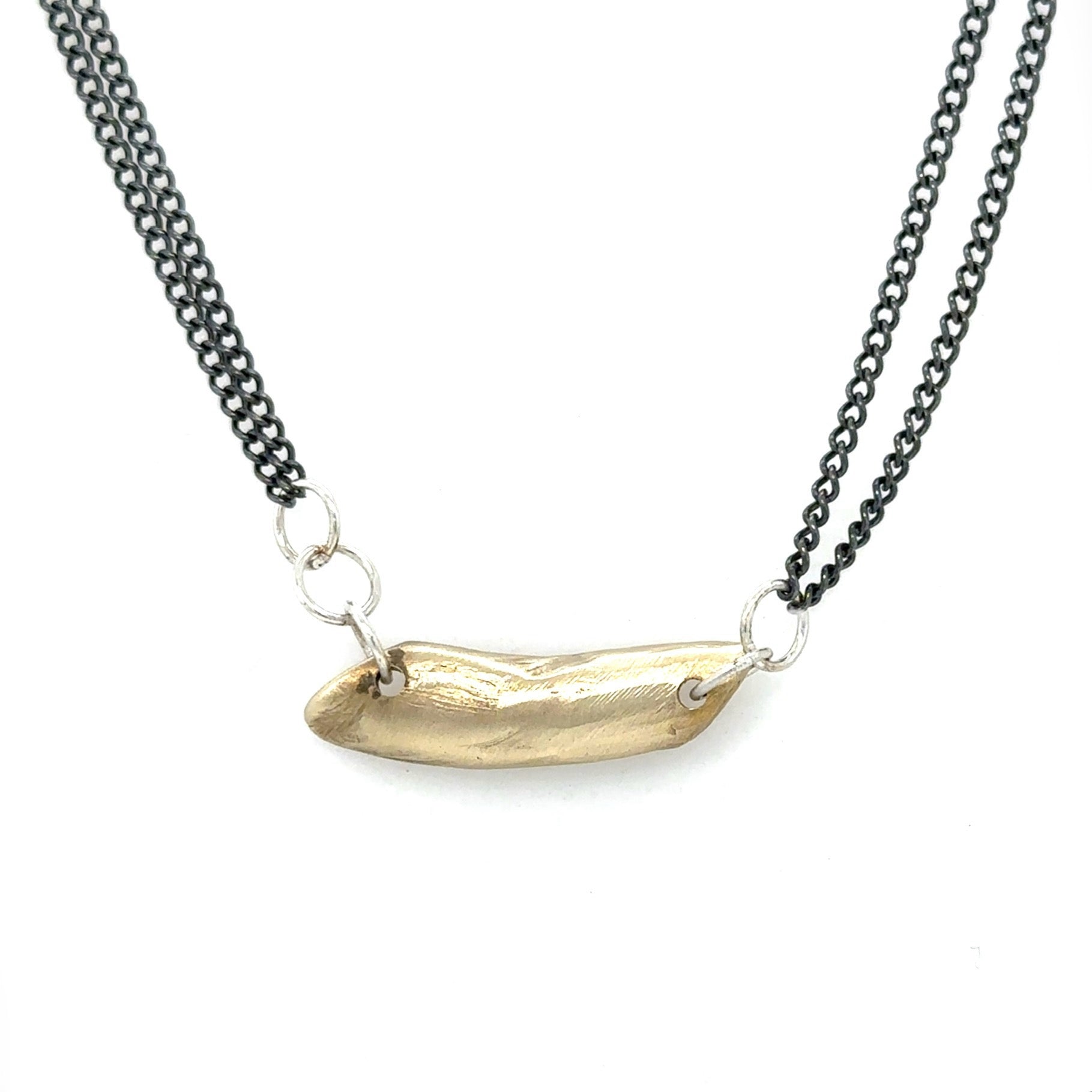 The Whisper Necklace rests softly at the nape of your neck, like a secret promise you carry close. A sculptural form anchors dual oxidized silver chains and it's raw edges are a reminder of the beauty that emerges from imperfection.