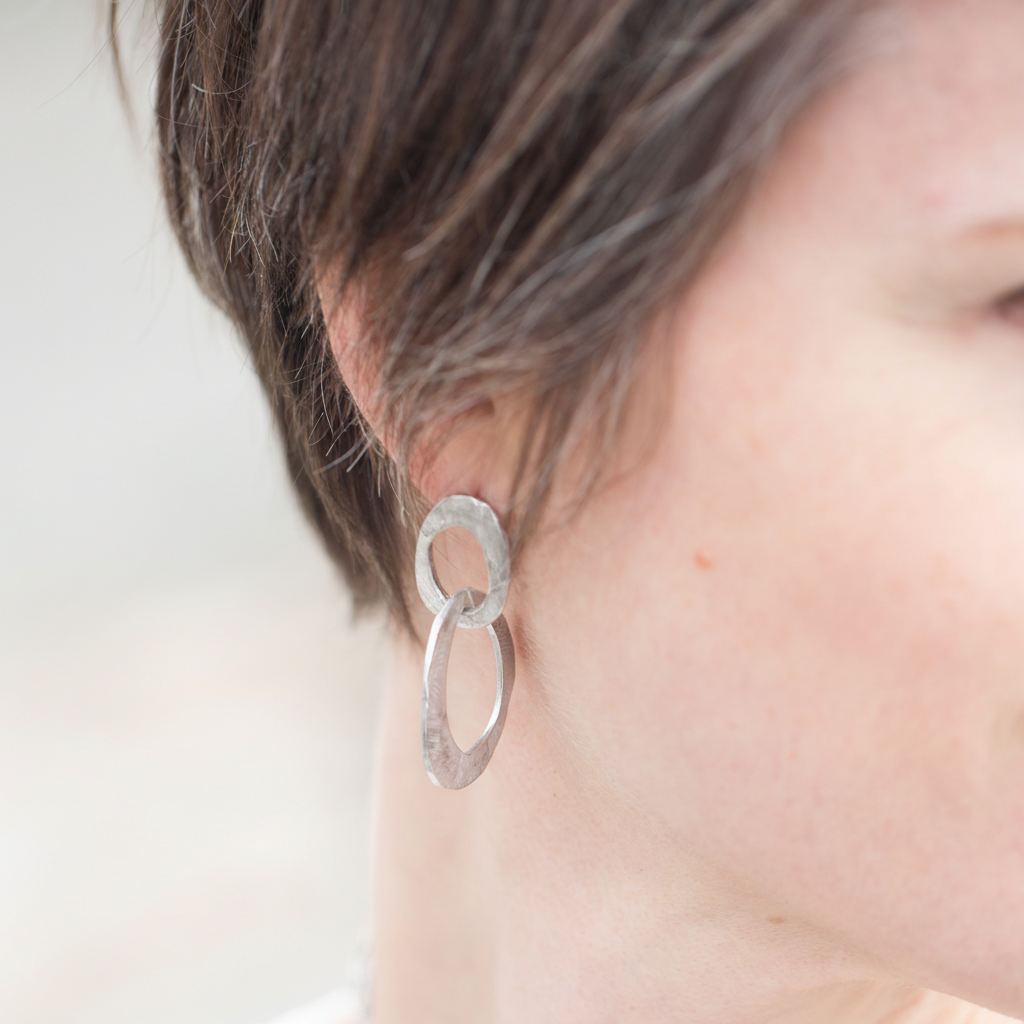 Skipping Stones Double Oval Hoop Earring in silver on model