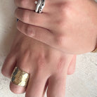 Close-up of Origin Ring in Bronze with Stacked Silver Odyssey and Constellation Rings on hands