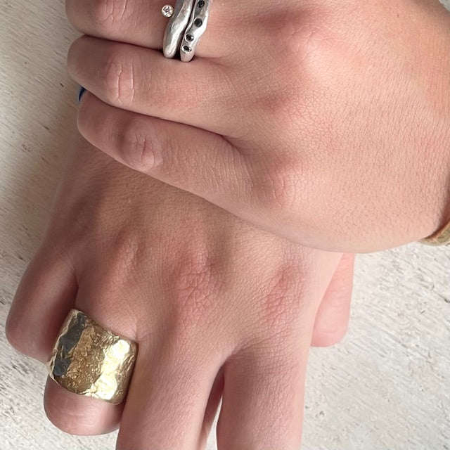 Close-up of Origin Ring in Bronze with Stacked Silver Odyssey and Constellation Rings on hands