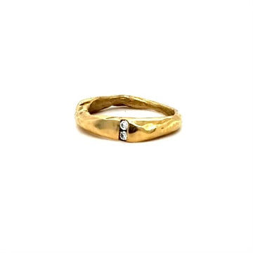 The Channel Ring is designed to channel your desires and aspirations, empowering you to manifest your dreams with unwavering determination. Handcrafted with the ancient lost wax casting technique, the 2 to 4mm organic band is bronze and features two brilliant 2mm white diamonds symbolizing harmony and balance.