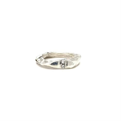 The Channel Ring is designed to channel your desires and aspirations, empowering you to manifest your dreams with unwavering determination. Handcrafted with the ancient lost wax casting technique, the 2 to 4mm organic band is sterling silver and features two brilliant 2mm white diamonds symbolizing harmony and balance.