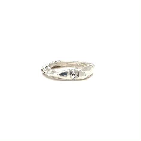 The Channel Ring is designed to channel your desires and aspirations, empowering you to manifest your dreams with unwavering determination. Handcrafted with the ancient lost wax casting technique, the 2 to 4mm organic band is sterling silver and features two brilliant 2mm white diamonds symbolizing harmony and balance.