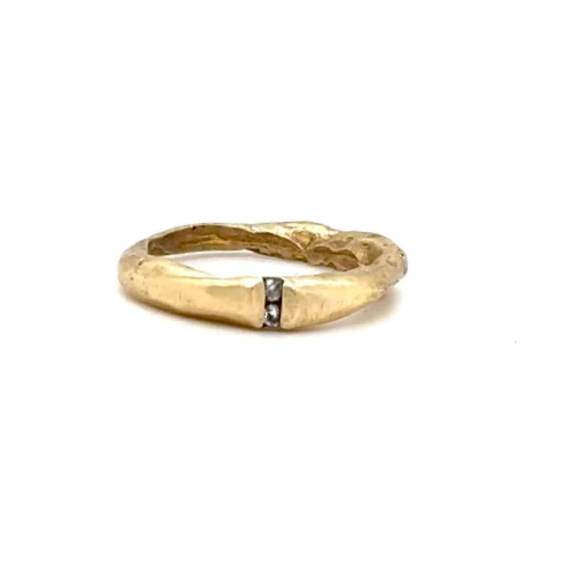 The Channel Ring is designed to channel your desires and aspirations, empowering you to manifest your dreams with unwavering determination. Handcrafted with the ancient lost wax casting technique, the 2 to 4mm organic band is bronze and features two brilliant 2mm white diamonds symbolizing harmony and balance.