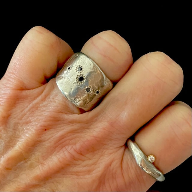 The Five Elements Ring in Silver with Odyssey Ring in Silver on persons hand 
