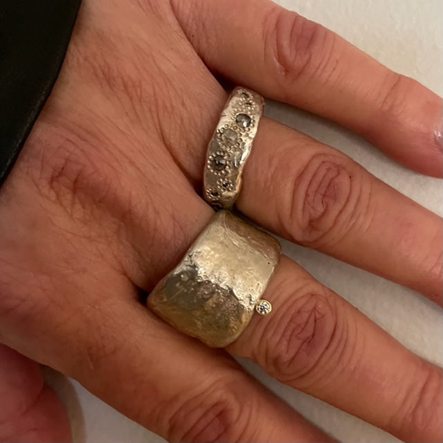 The Thrive Ring with Salt & Pepper Diamonds and the Relic Ring in Silver shown on persons hand 