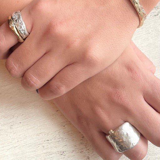 Thrive Ring with Salt & Pepper Diamonds; Channel Ring in Bronze; Relic Ring in Silver on persons hands