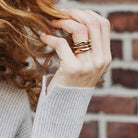 Close up of Model wearing three stacked Element Rings in Bronze