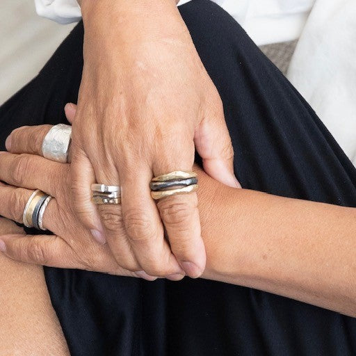 Various Chikahisa Studio Ring stacks on persons hands