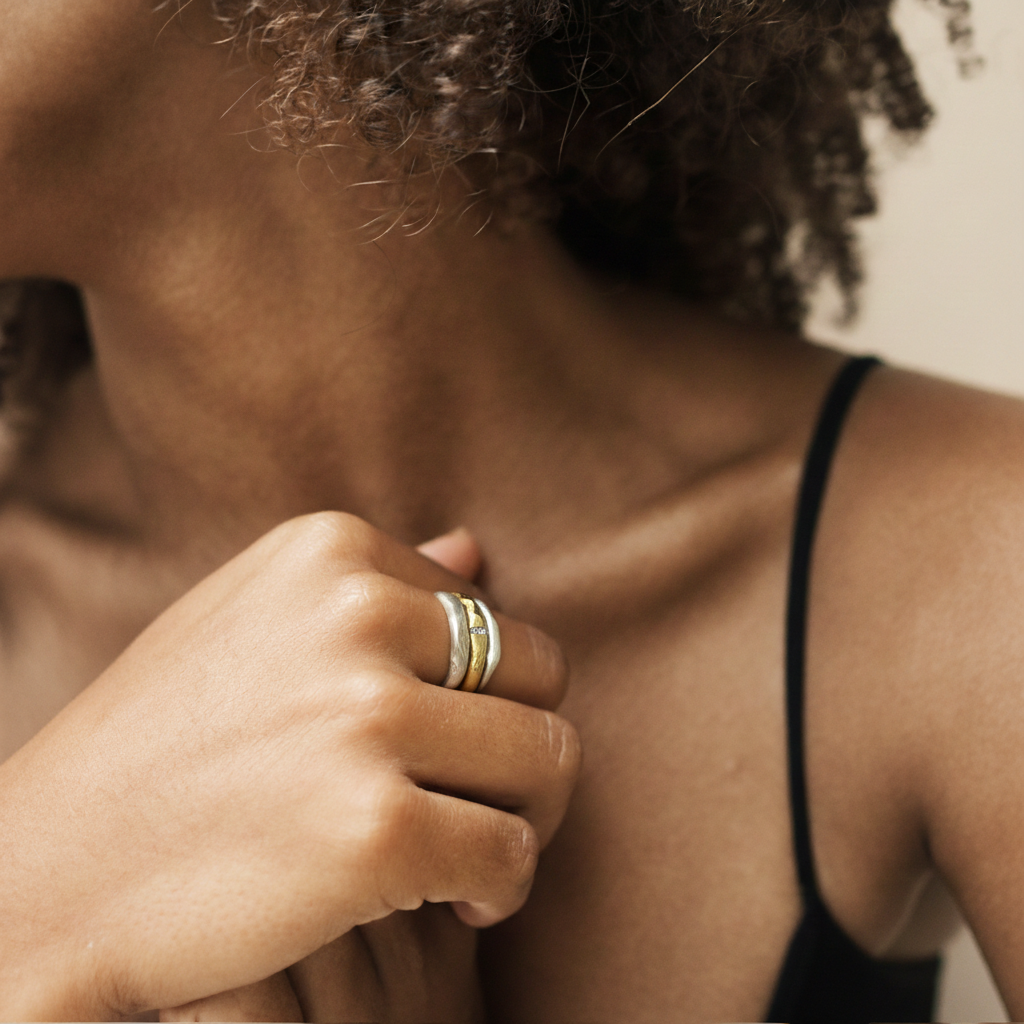 Model wearing ring stack of one Channel Ring in Bronze and two Silver Element Rings