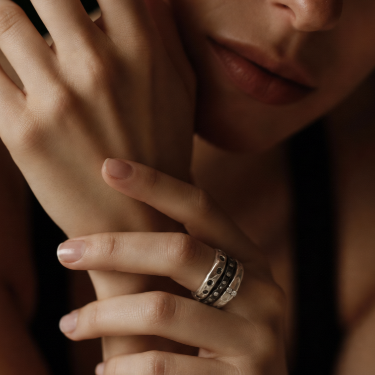 Constellation, Mystic Radiance, and Channel Ring shown stacked on model's hand