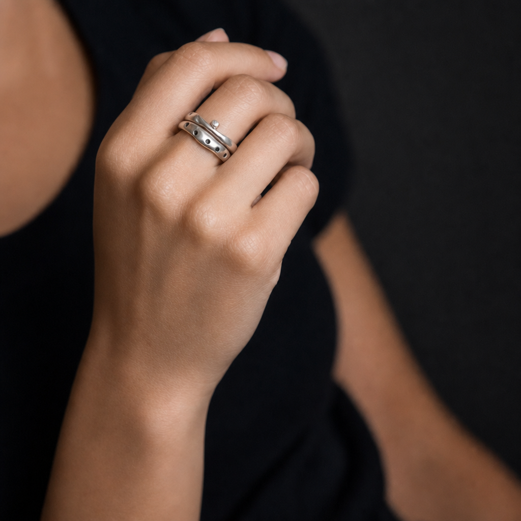Constellation and Odyssey Rings in Silver on models' hand