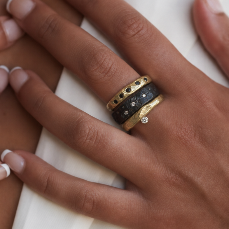 Odyssey and Constellation Rings in Bronze with Venus Ring in Oxidized Silver on Model