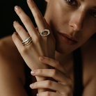 Model wearing Ovum Ring in Silver with Stacking Element Rings and Odyssey Ring