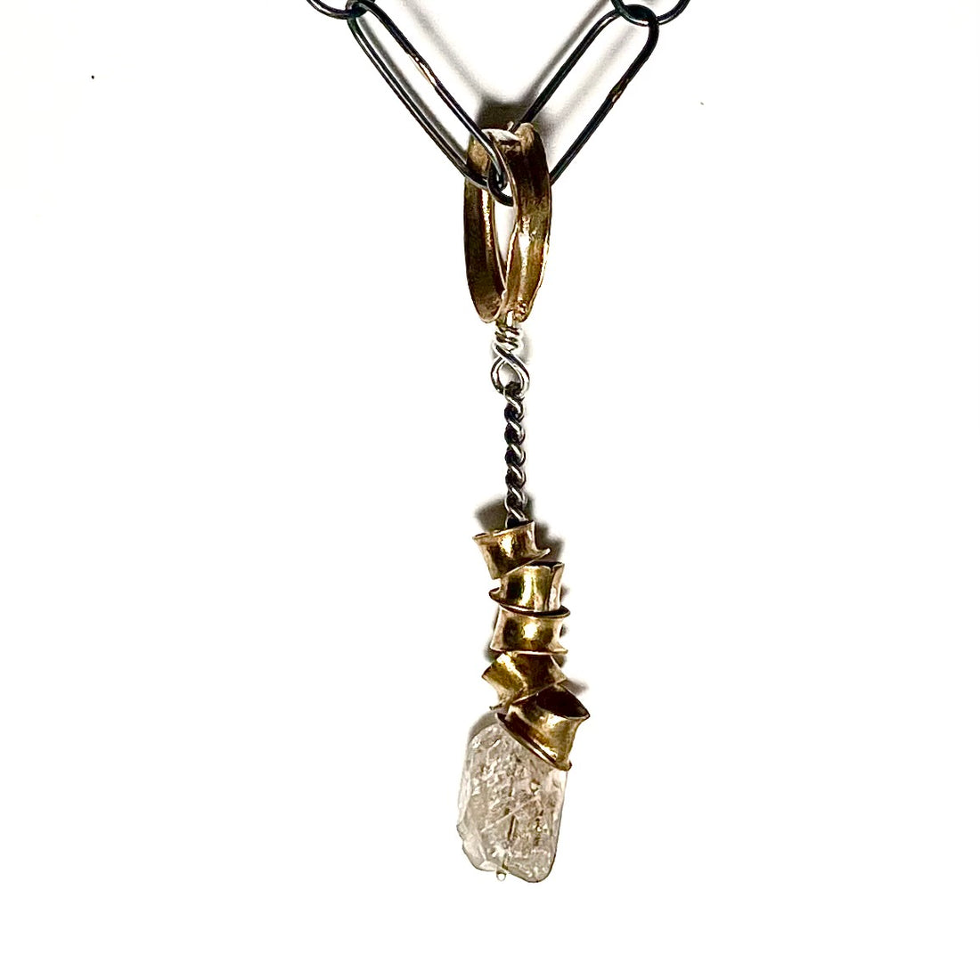 The Rooted Talisman draws its inspiration from the awe-inspiring design and functionality of the human spinal cord. Much like the intricate network of the spine, this talisman symbolizes strength, resilience, and the remarkable agility that resides within the core of our being.  Shown here on Paperclip Chain.