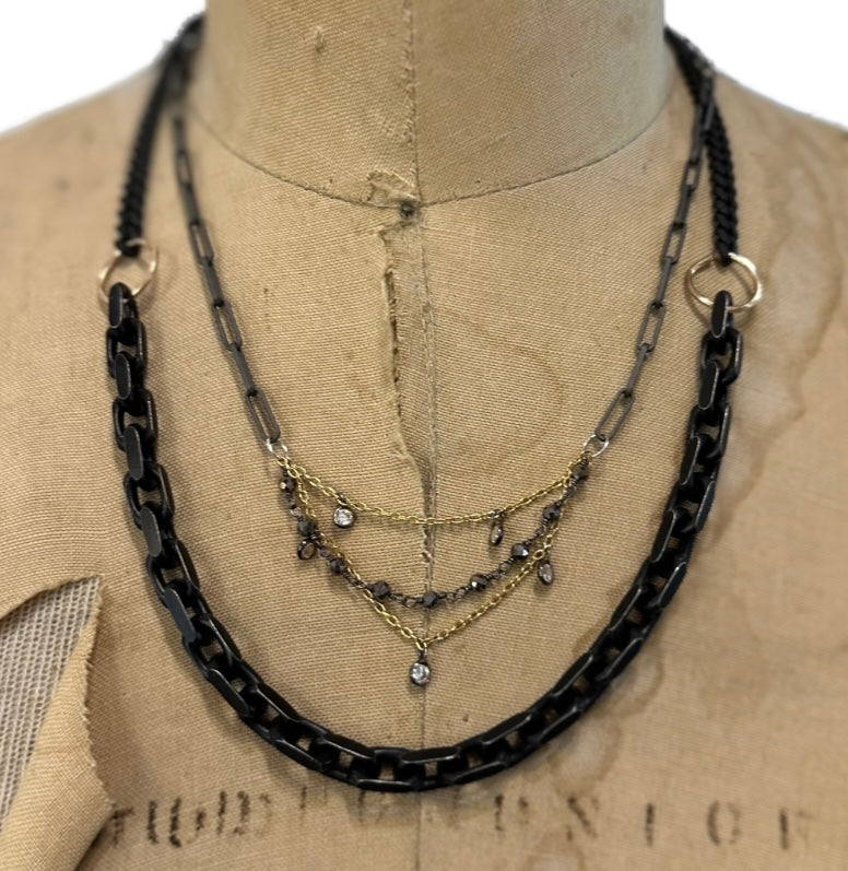 The Black and Gold Statement Necklace from our Sacred Bloom Collection shouts strength and resilience. Black silver, weighty chain, and bronze accents are a reminder: we are fragile but fierce. Wear your attitude....Bold yet beautiful. 