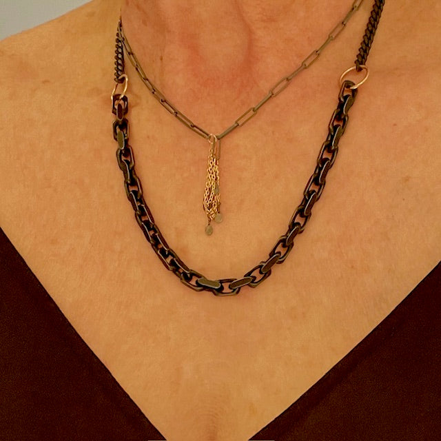 The Black and Gold Statement Necklace from our Sacred Bloom Collection shouts strength and resilience. Black silver, weighty chain, and bronze accents are a reminder: we are fragile but fierce. Wear your attitude....Bold yet beautiful. 
