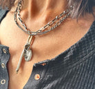 Necklace with a pendant worn by a person, close-up view.