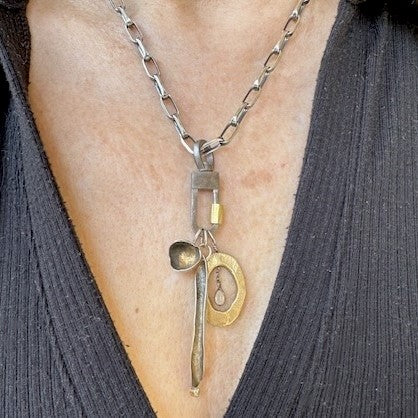 The Lock Connector is made of solid sterling silver with a 18k gold-plated screw closure and is made to swivel so your Talisman Pendants will move with your body.